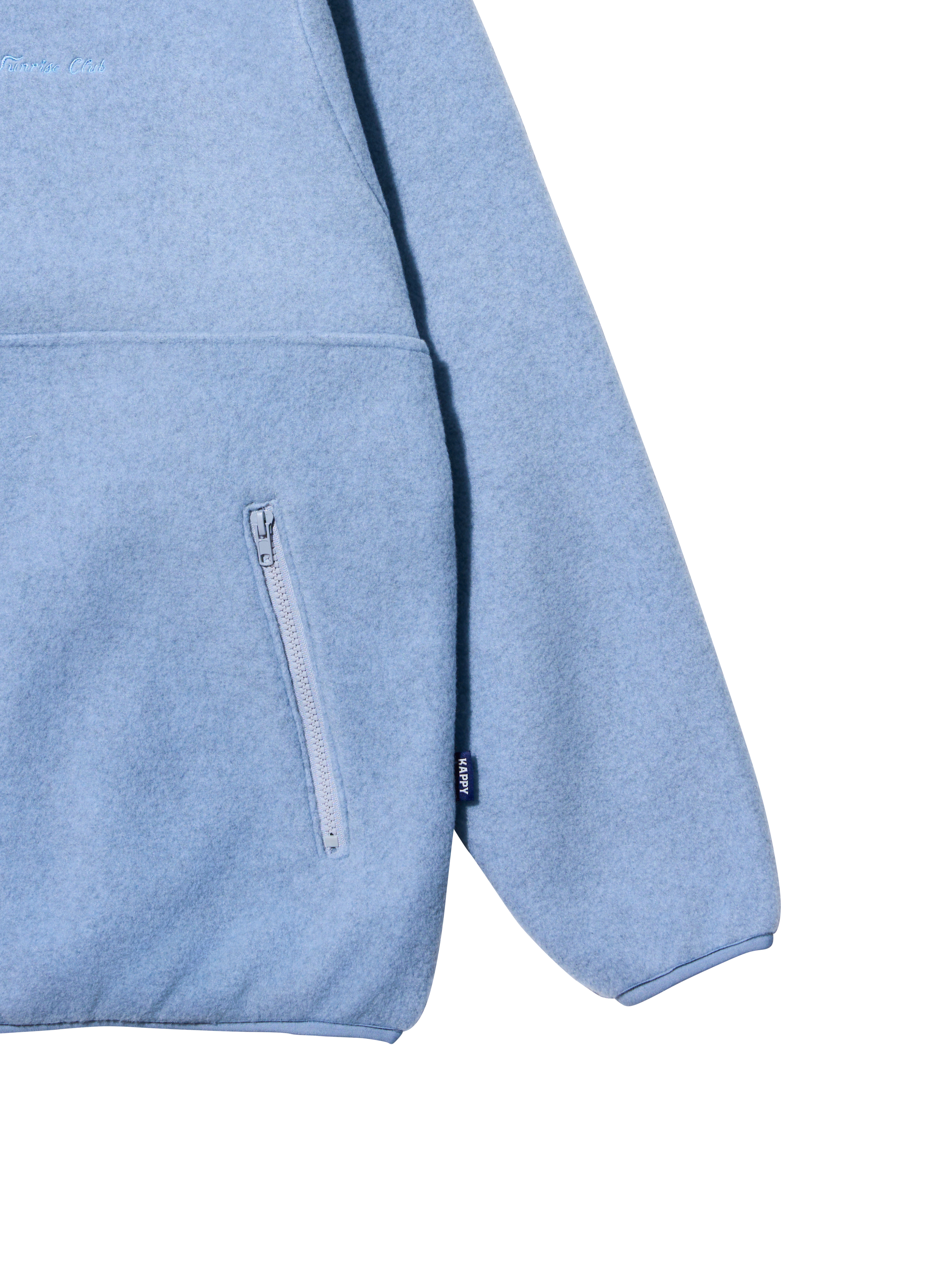 Close-up detail of a light blue heathered fleece hoodie showing a side zippered pocket, ribbed cuffs, and a small black brand tag on the sleeve.