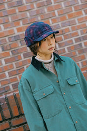 ear flaps in a dark blue and purple pattern, featuring white embroidered text on the front that reads 'Sunrise Club'.