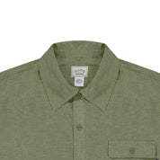 close up of Khaki Green shirt with collar and pocket with a button on a white background