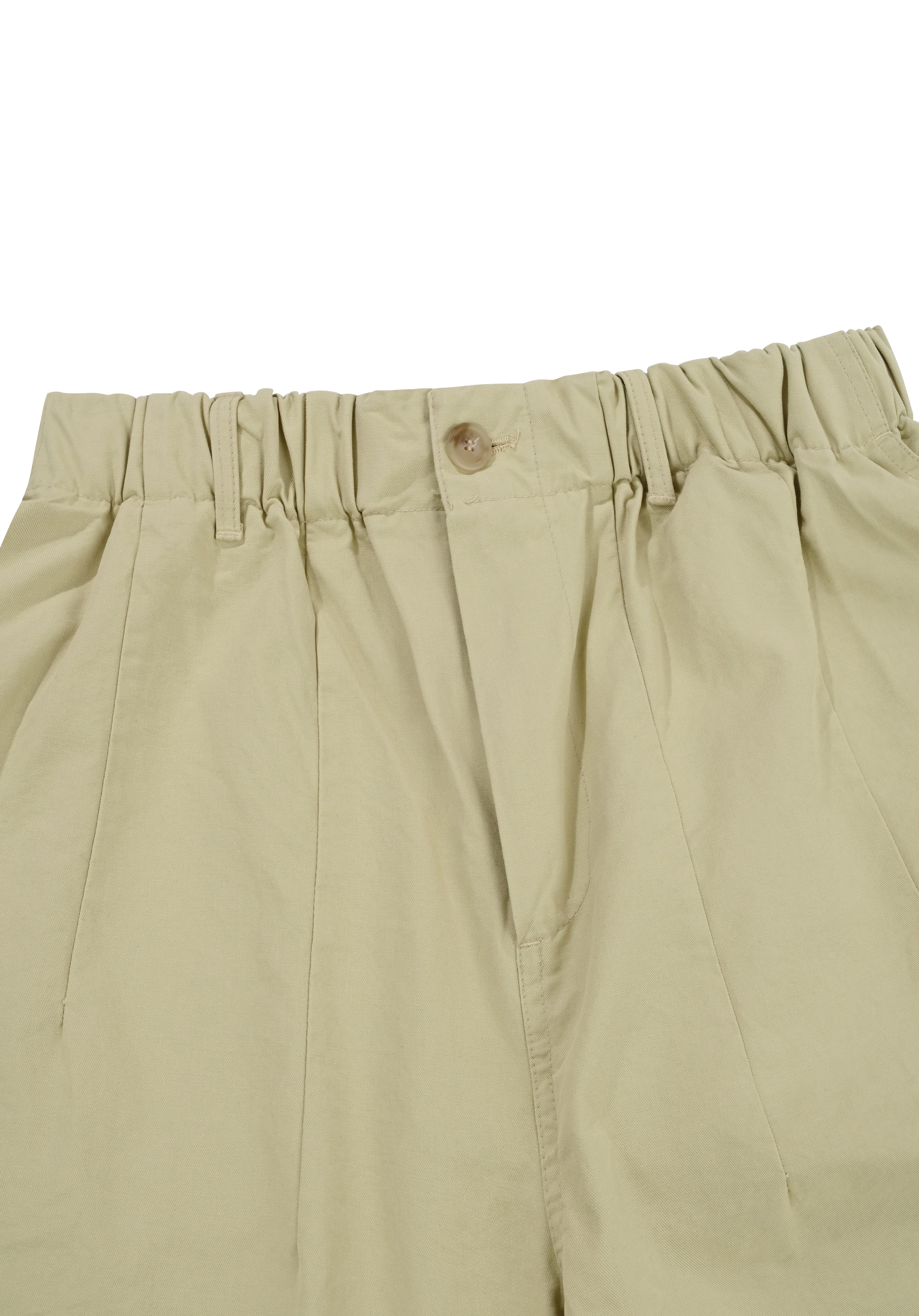 close up of elasticated waistband of Beige pants with a button on a white background