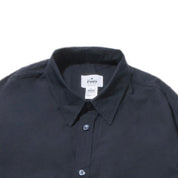 Close up of Navy shirt with a visible brand label on a white background