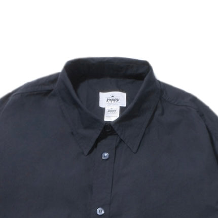Close up of Navy shirt with a visible brand label on a white background