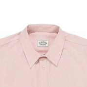 close up of Pink shirt collar with a visible brand label on a white background
