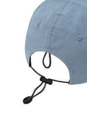 rear view of a light blue cap showing toggle and string to adjust the hat fit