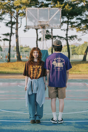 Two people standing on a basketball court with trees in the background