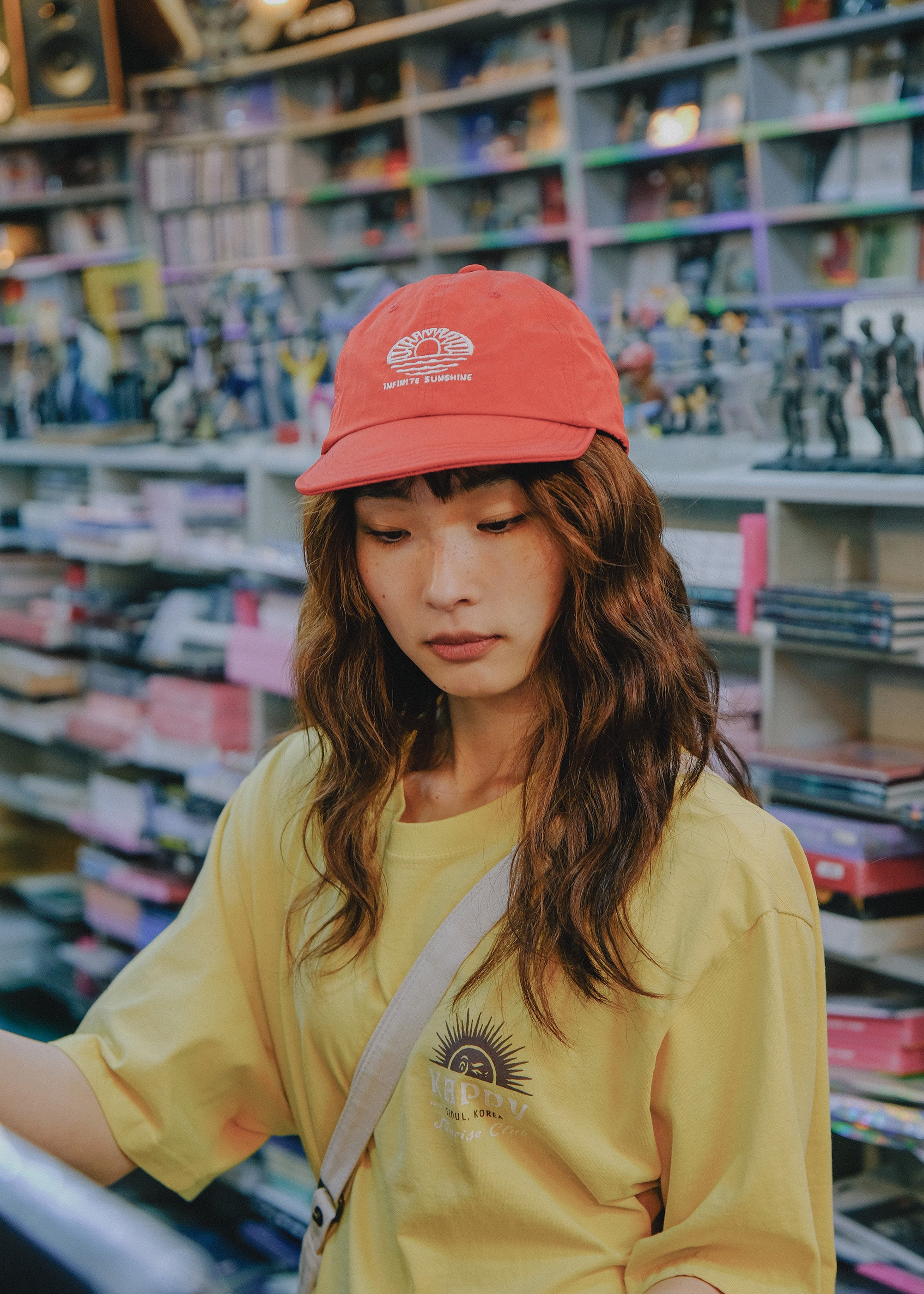 Person wearing a red cap and yellow shirt in a store setting