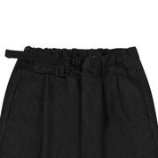 Black denim pants with a belt on a white background