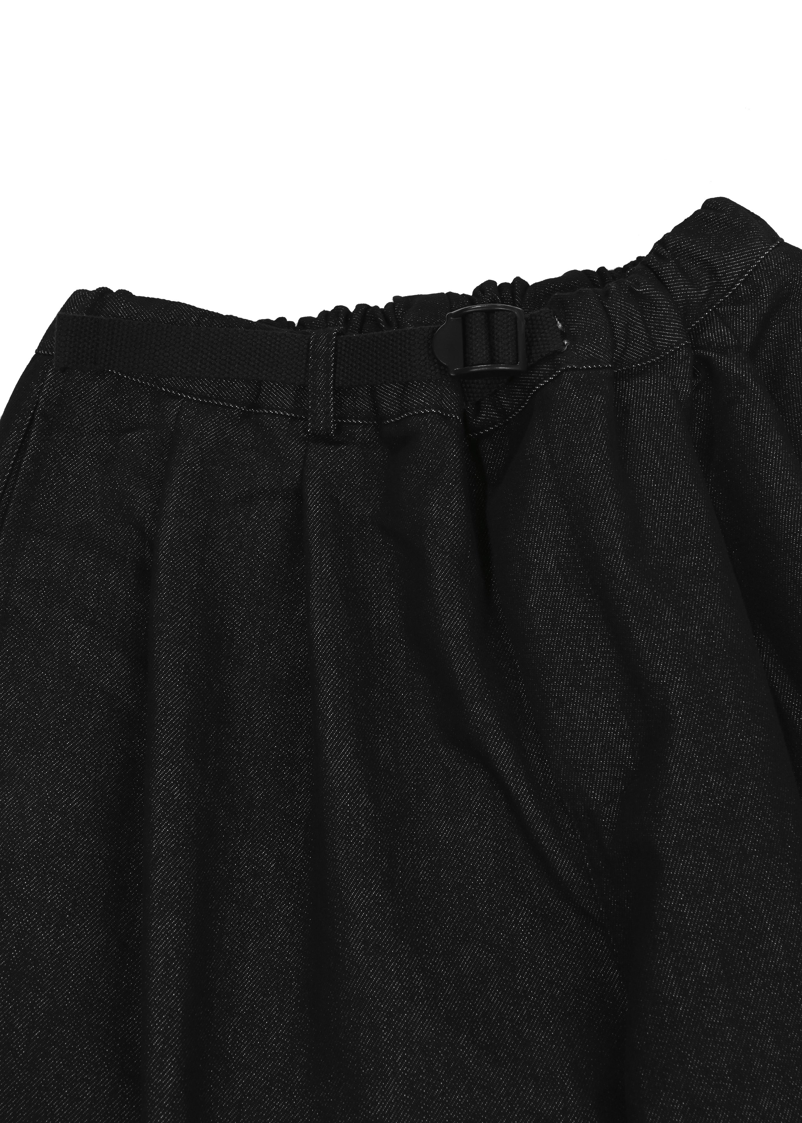 Close-up of black denim pants with a belt on a white background
