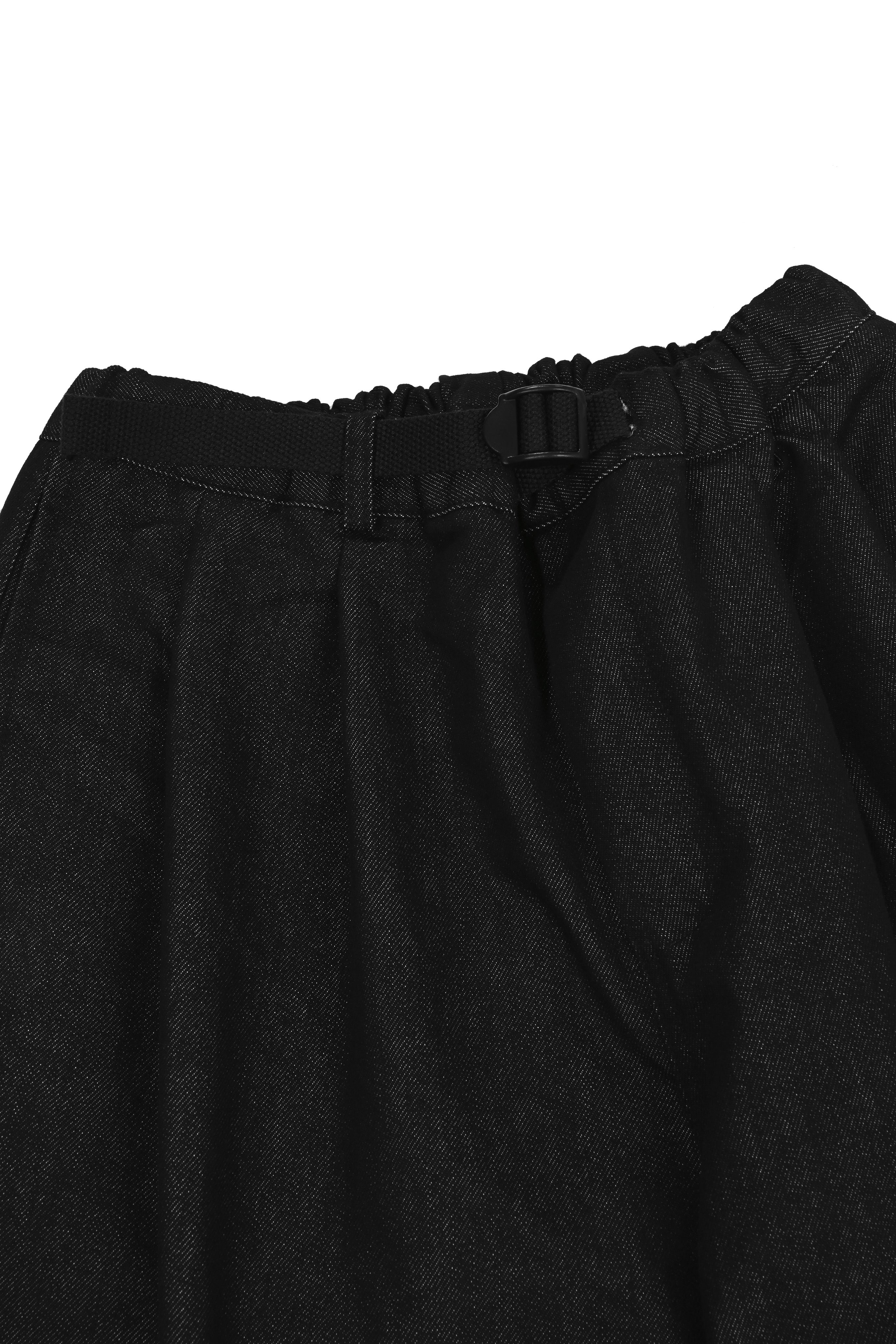 Close-up of black denim pants with a belt on a white background