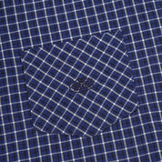 Close-up of pocket on a blue and white checkered shirt with a button.