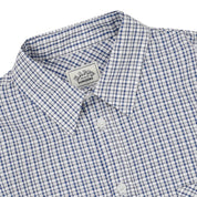 Long sleeve white and blue  checkered shirt with a visible brand label on a white background