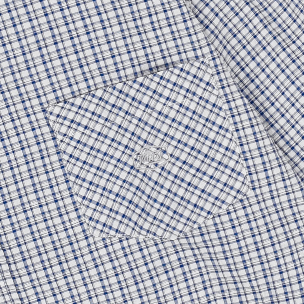 Close-up of a blue and white checkered shirt with a pocket.